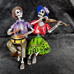 Two Musicians on a Log - calavera sculpture