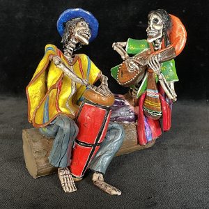 Two Musicians on a Log - calavera sculpture
