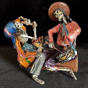Two Musicians on a Log - calavera sculpture